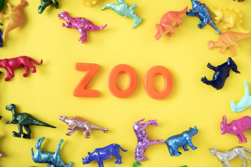 Free Image of Flat lay of the text ZOO arranged with plastic alphabet blocks surrounded with colorful toy animals 
