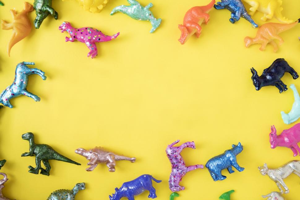 Free Image of Colorful toy animals on yellow surface 