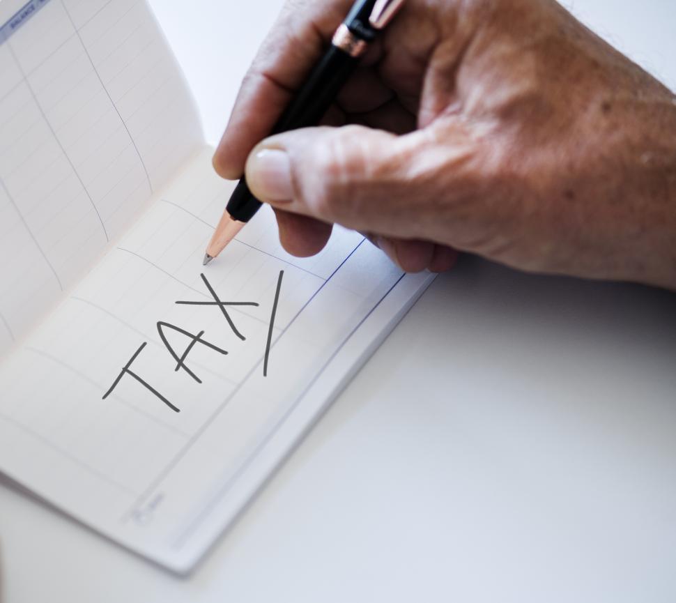 Free Image of Close up of the word TAX being written on a bankbook 