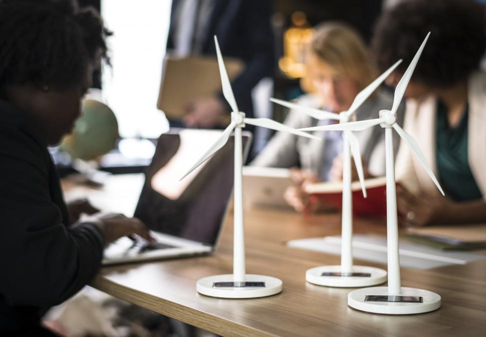 Free Image of Miniature models of wind turbines on the office table 