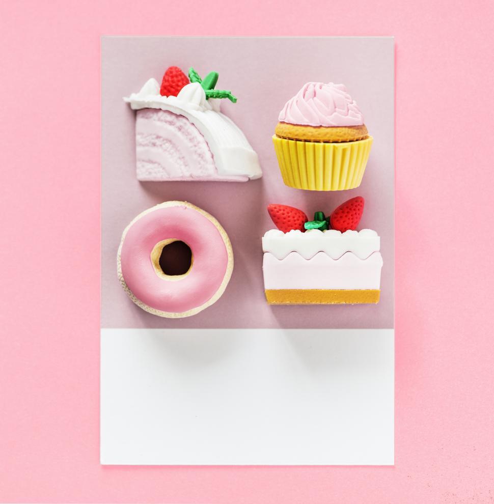 Free Image of Flay lay of cake, cupcake, doughnut and pastry on a card 
