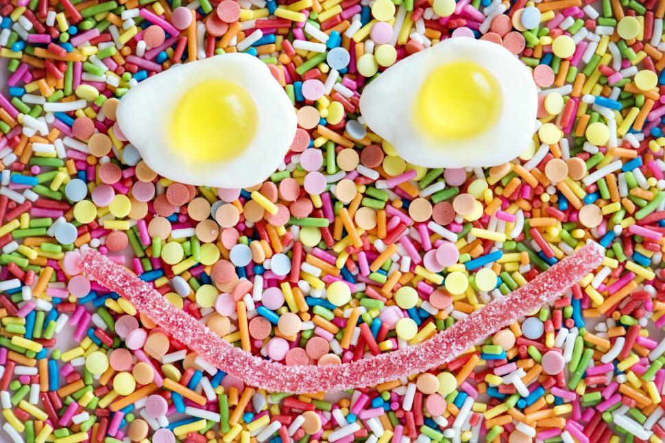 Free Image of Close up of colorful candy sprinkles with a smiley formed over them 
