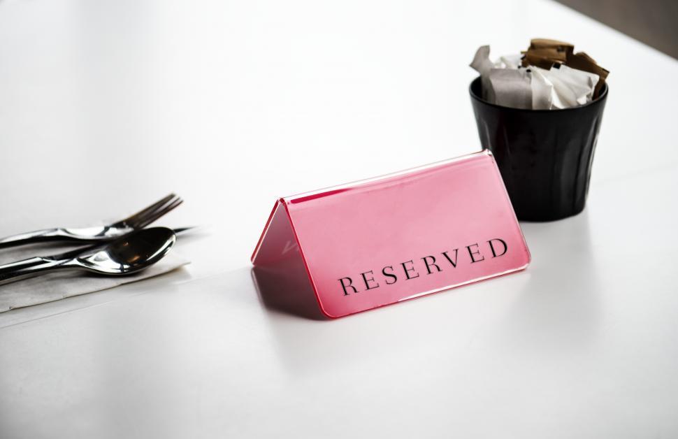 Free Image of Close up of a  Reserved  sign on the table 