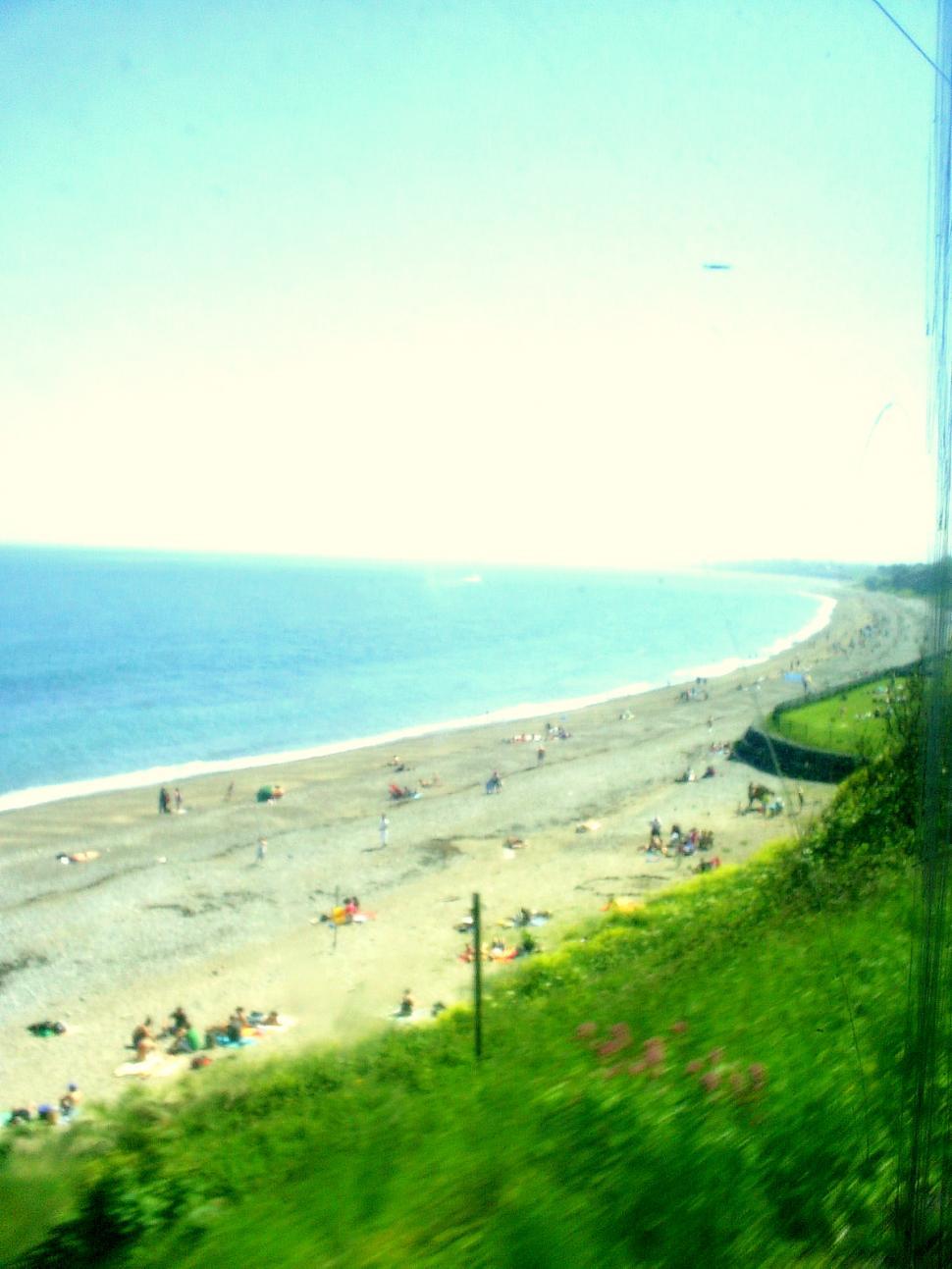 Free Image of A View of a Beach From a Train Window 