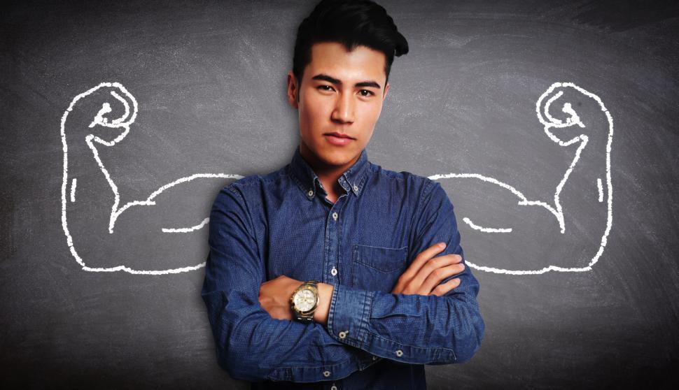 Free Image of Hidden Strengths - Young Man with Muscular Arms on Blackboard 