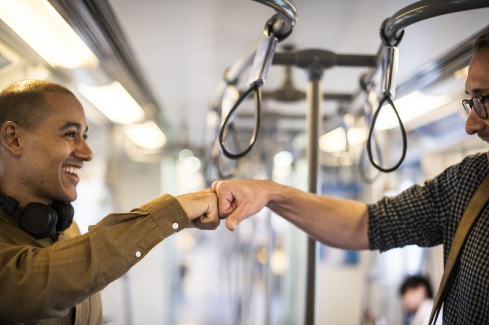 Free Image of Commuters giving Fist Bump on the Train 