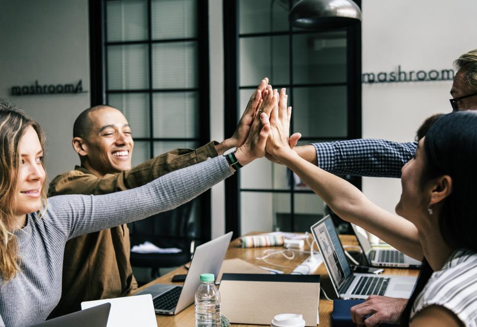 Free Image of Group giving high five in the office 
