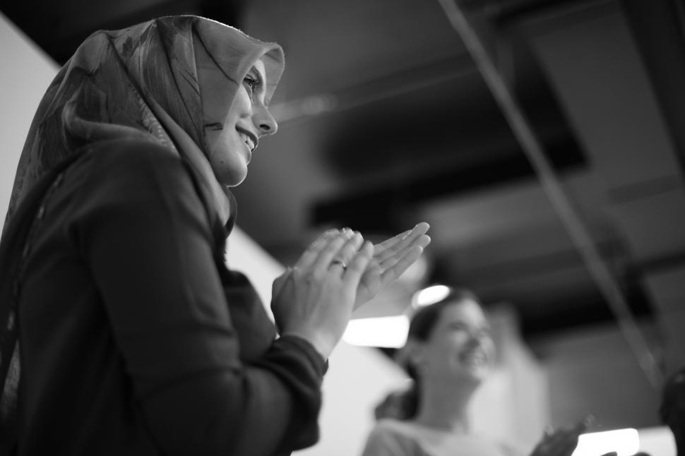 Free Image of A young woman wearing headscarf clapping 