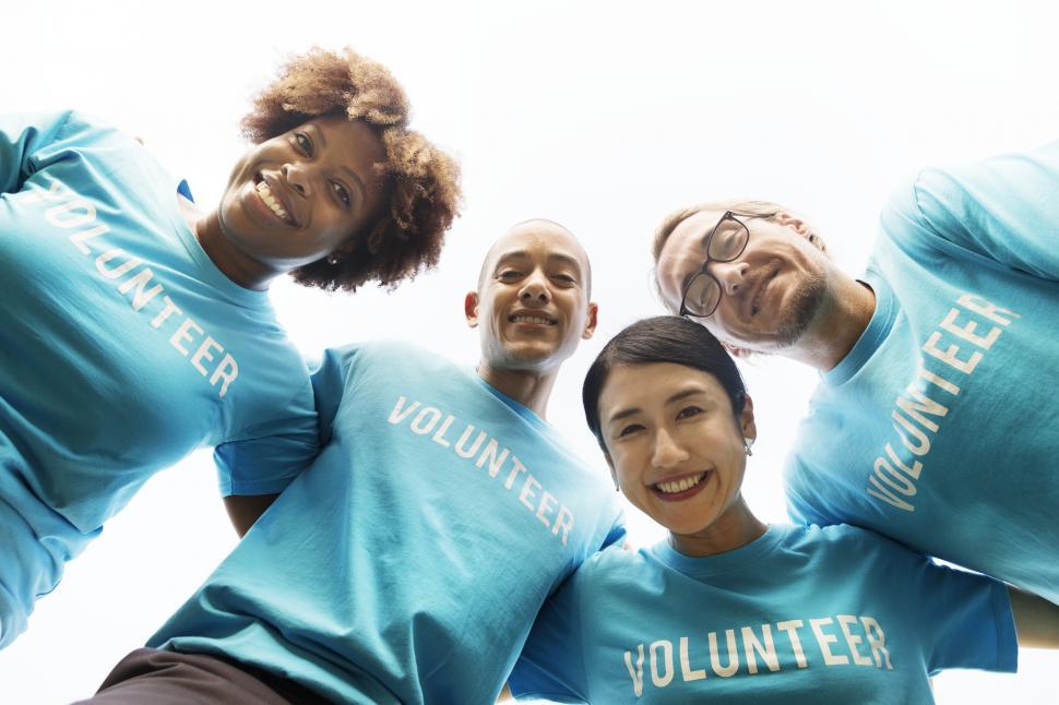 Free Image of Group of happy volunteers, arms around each other 