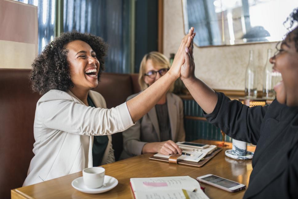 Free Image of Laughing people giving high five in the cafe 