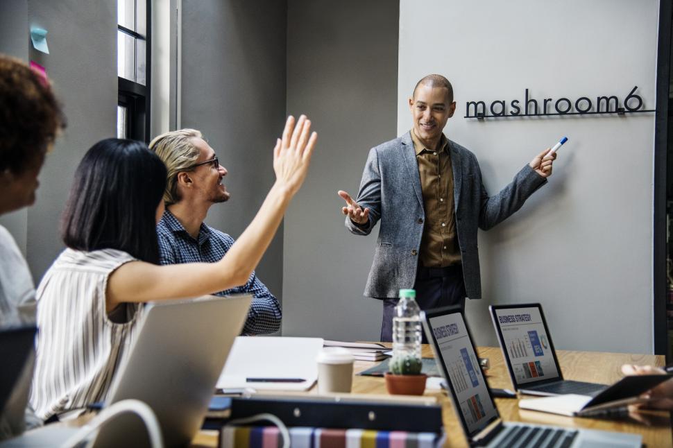 Free Image of Raising a hand in a business meeting 