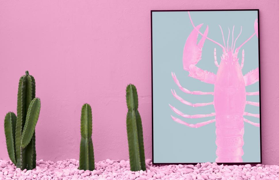 Free Image of Home decor with a lobster in a picture and cactus plants 