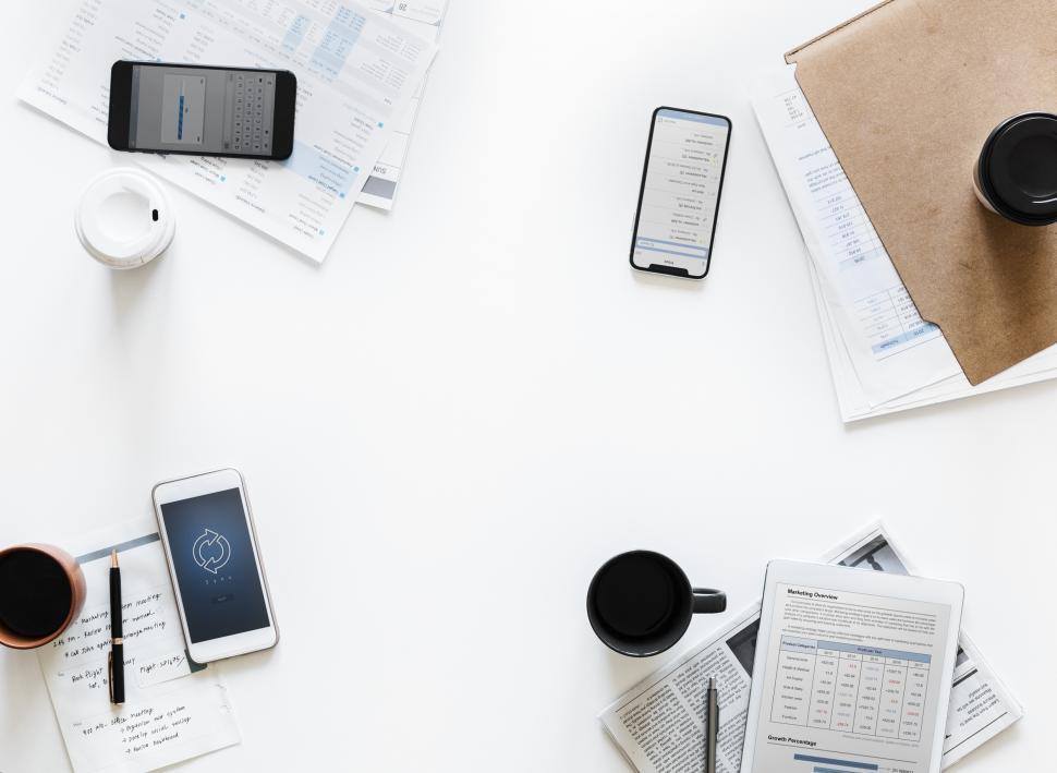Free Image of Flat lay of mobile phones on an empty meeting table 