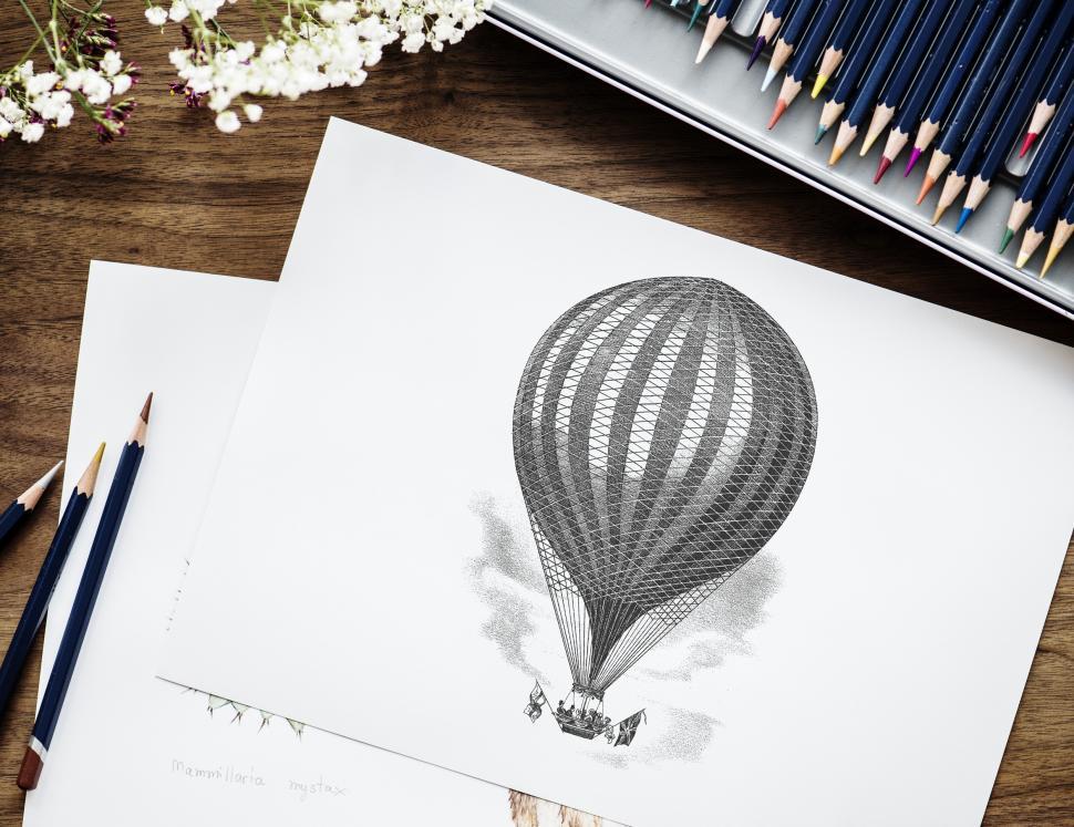 Free Image of Flat lay of a sketch of hot air balloon with color pencils 