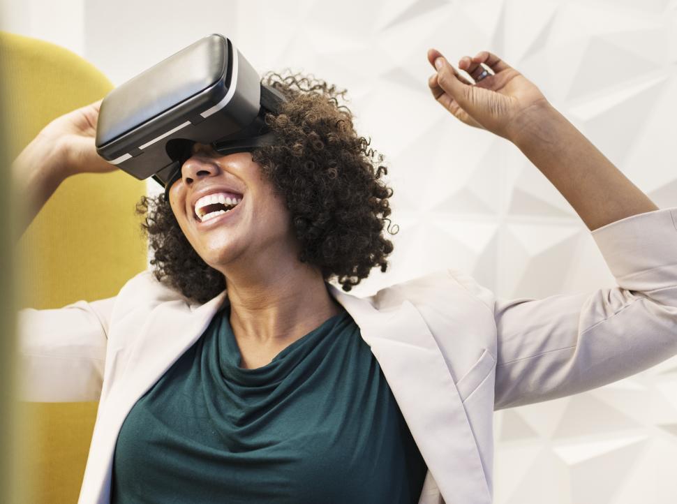 Download Free Stock Photo of Excited woman trying a virtual reality headset 