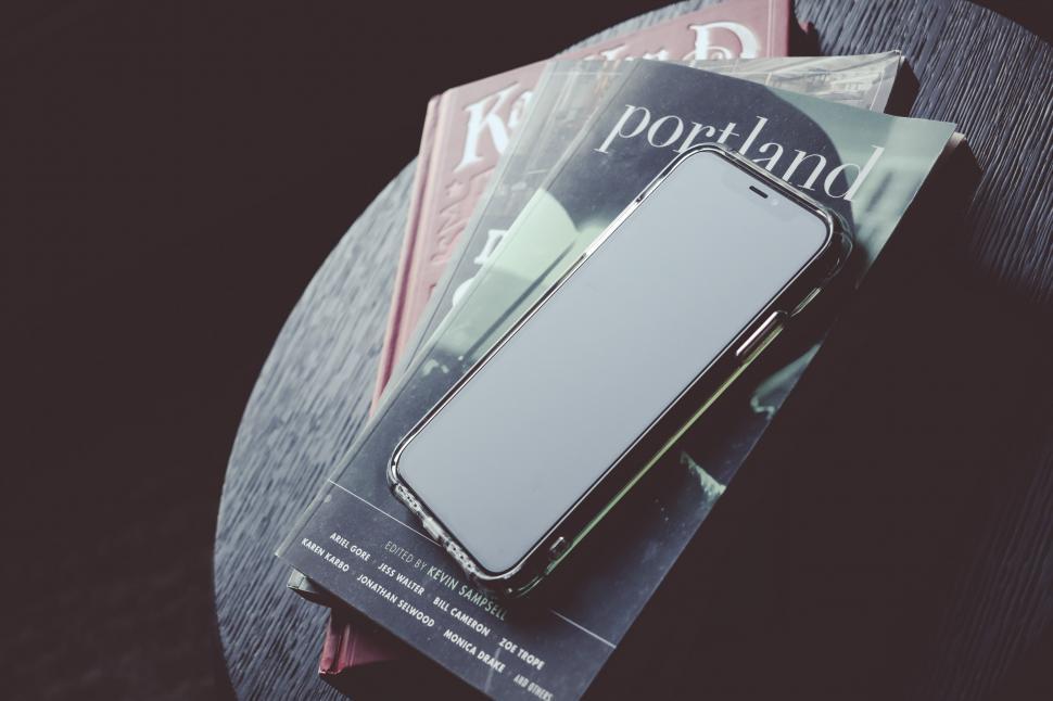 Free Image of Mobile phone on top of books 