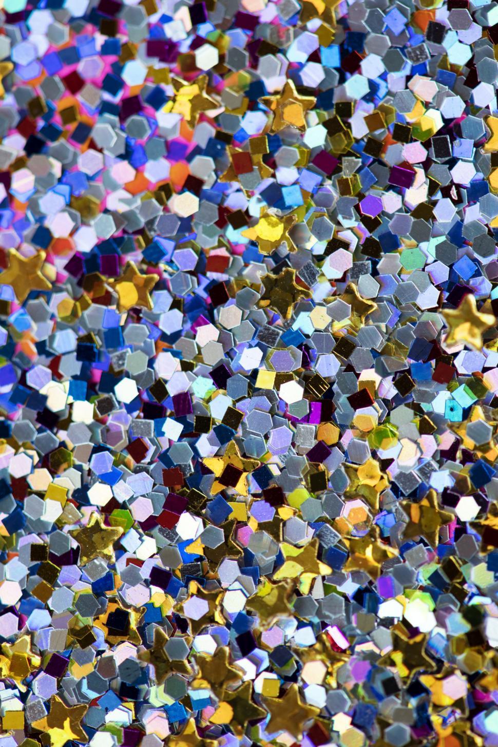 Free Image of Blue, yellow and violet hexagonal and star shaped glass glitter sparkles 