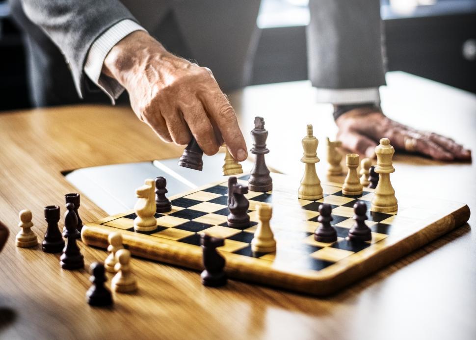 Free Image of Close up of a person s hand playing chess 