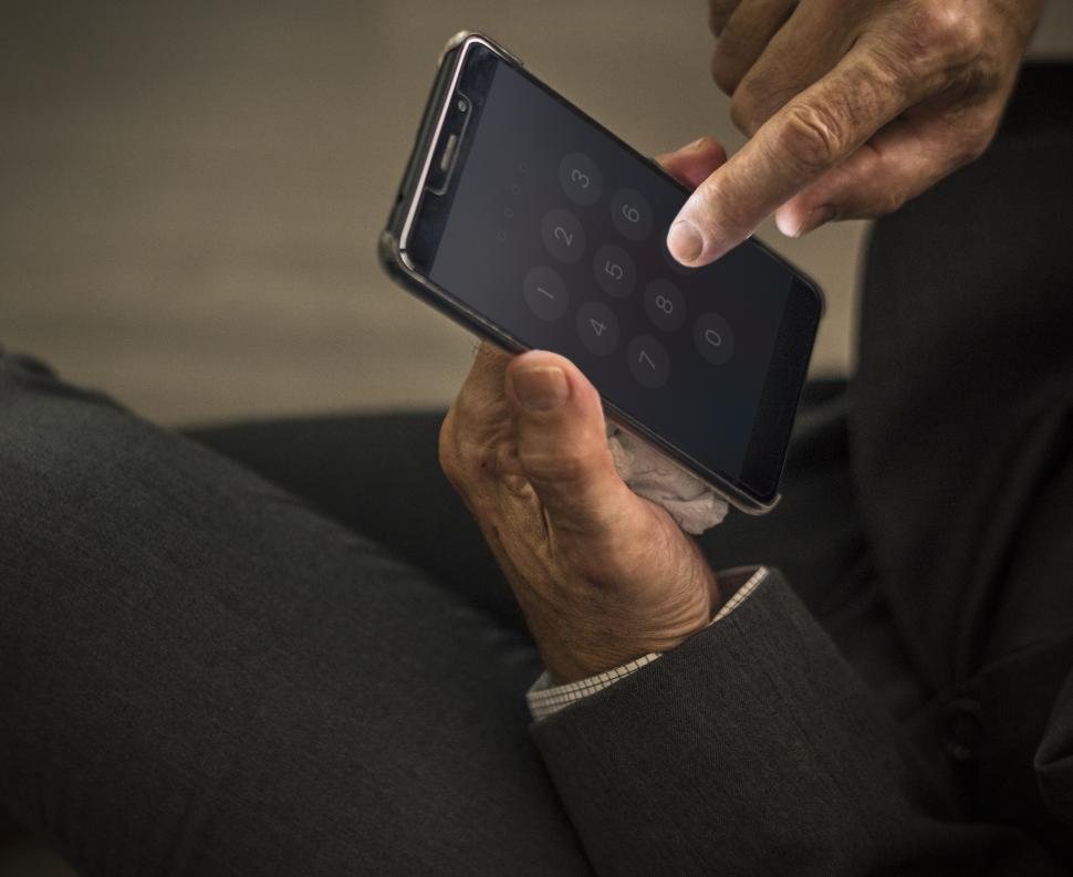 Free Image of Close up of hands interacting with a mobile phone screen 