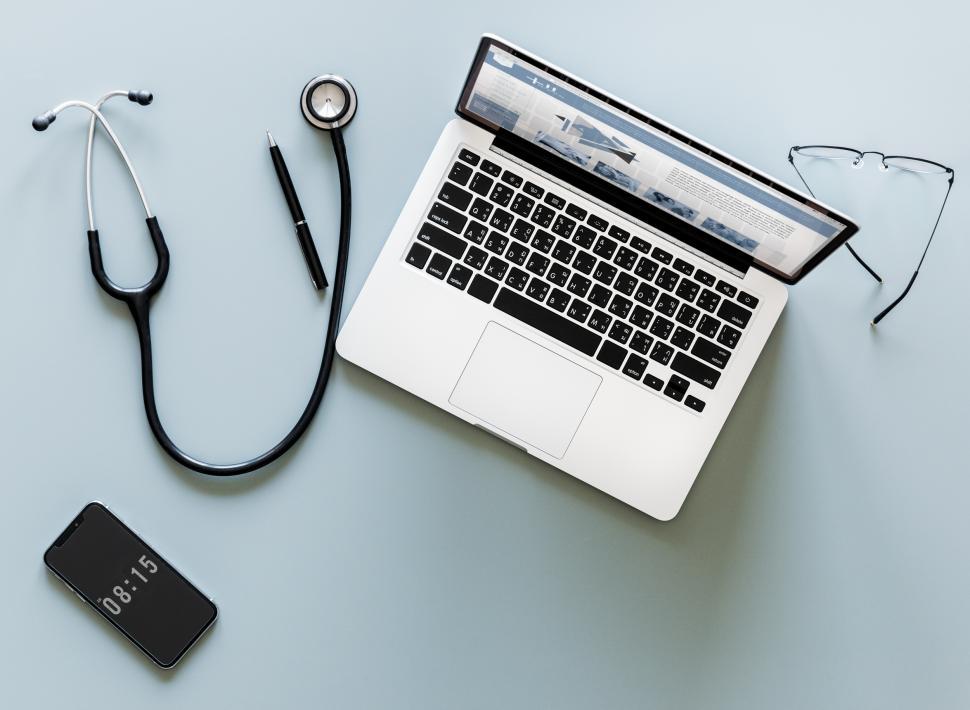 Free Image of Overhead view of a laptop and a stethoscope 