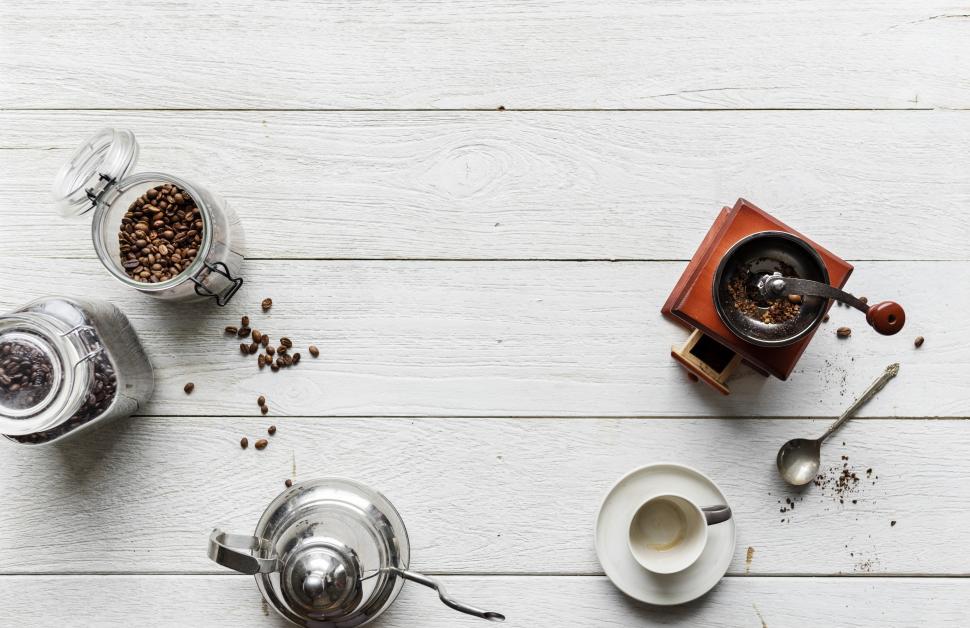 Free Image of Hot water kettle and vintage manual coffee grinder on white board background 