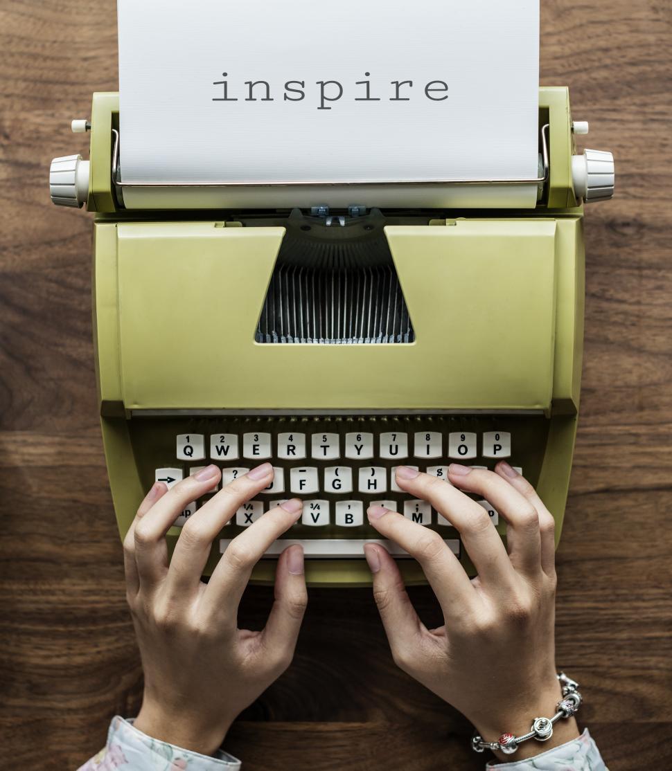 Free Image of Typing on a green vintage typewriter - INSPIRE written out 