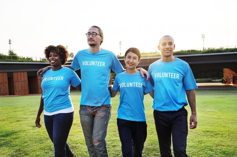 Free Image of A group of multiethnic volunteers walking together on the grass 