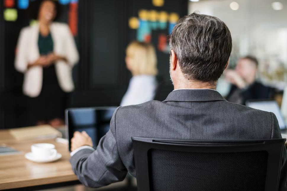 Free Image of Back of a man watching colleagues in a meeting 