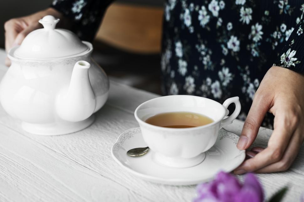 Free Image of Close up of a woman with tea and teapot 