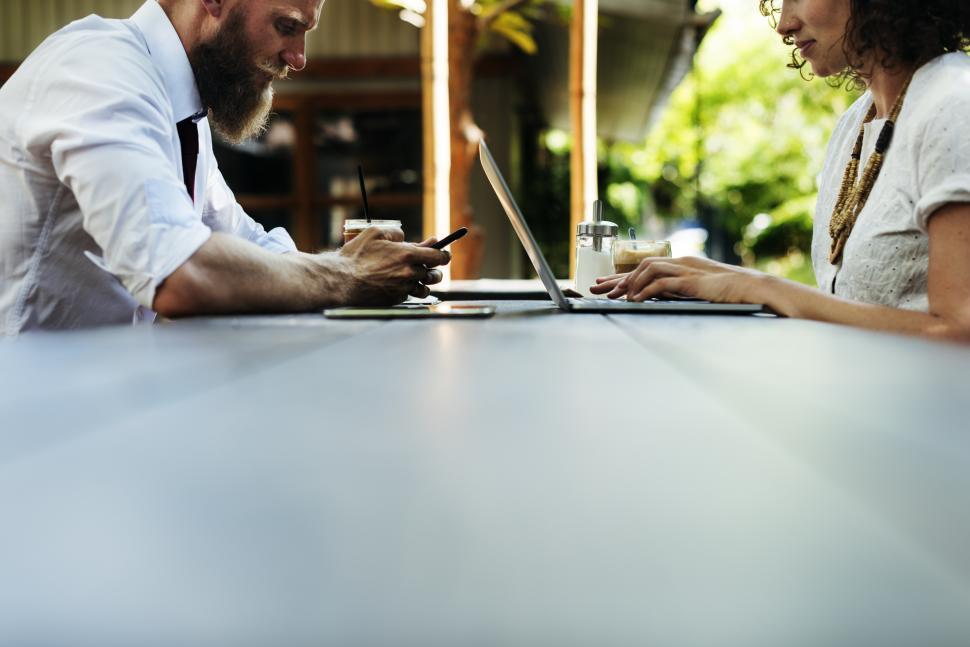 Free Image of Close up of two business people working with table foreground 