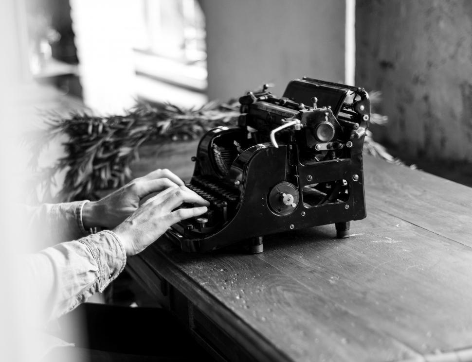 Free Image of Black and white of typing on a vintage typewriter 