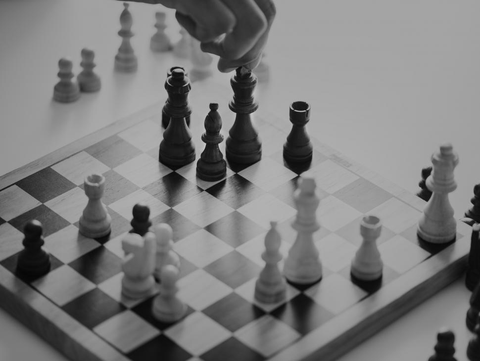 Free Image of Close up of a person s hand playing chess, monochrome 