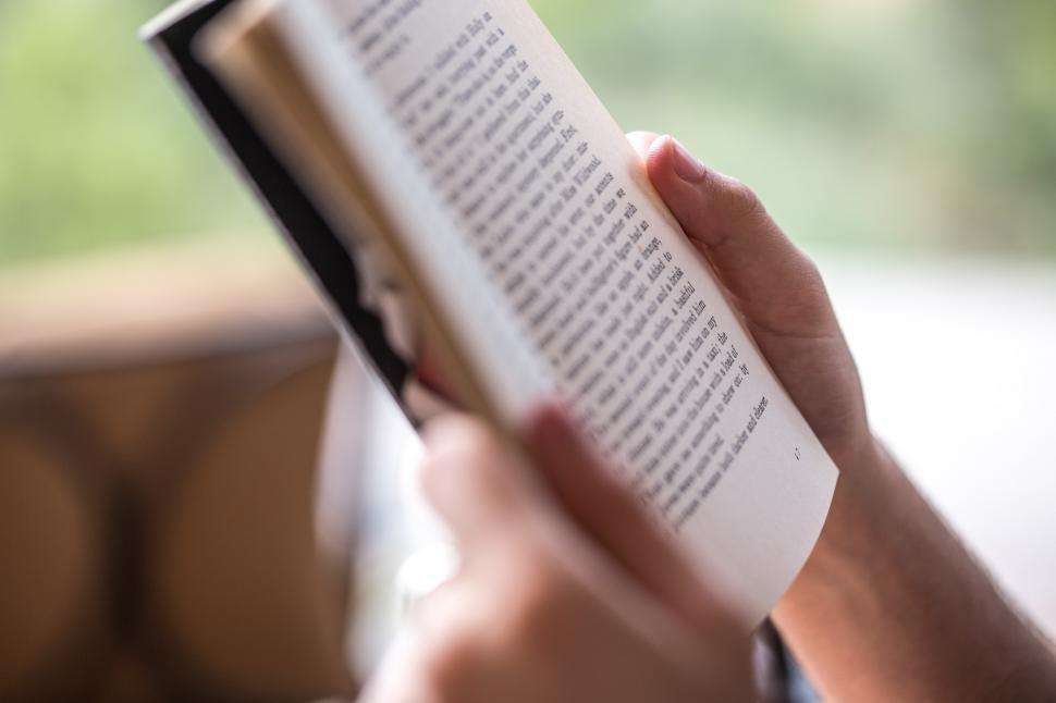 Free Image of Hands of a person reading a book 