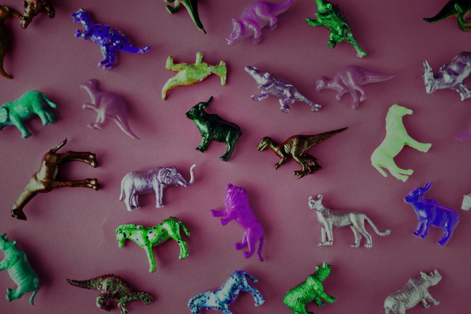 Free Image of Inverted color image of toy animals on red surface 