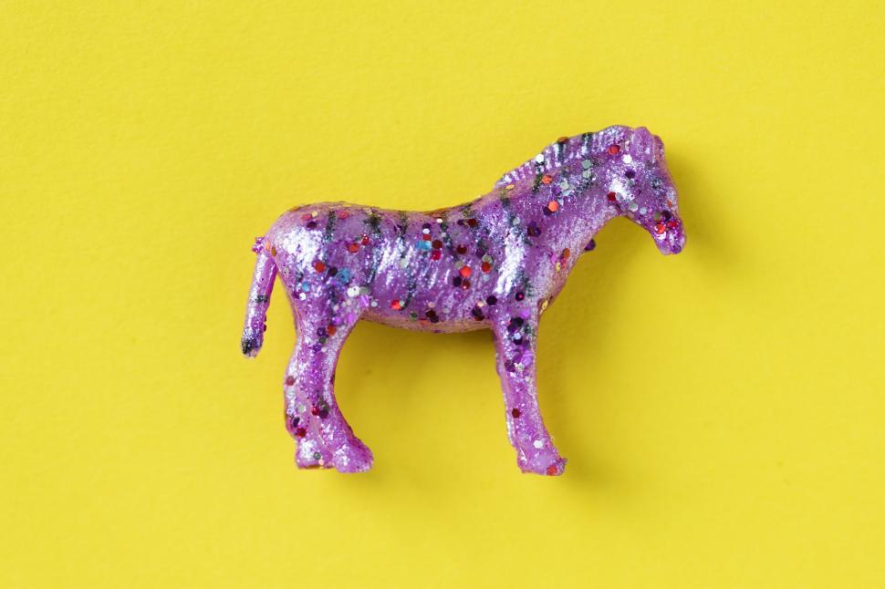 Free Image of Flat lay of a glittery toy horse 