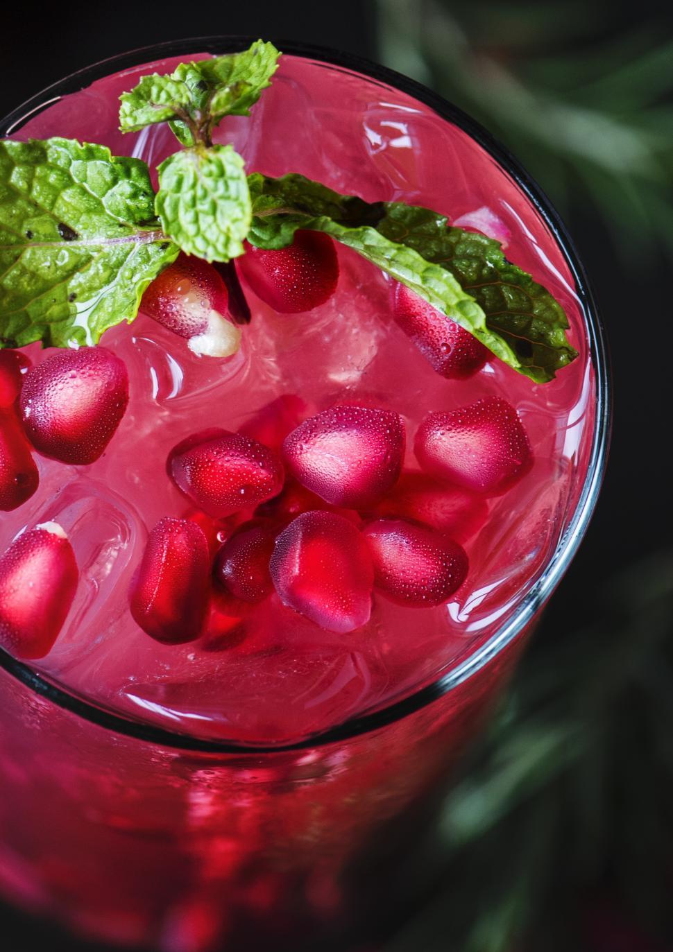 Free Image of Close up of a glass of chilled beverage garnished with pomegranate 