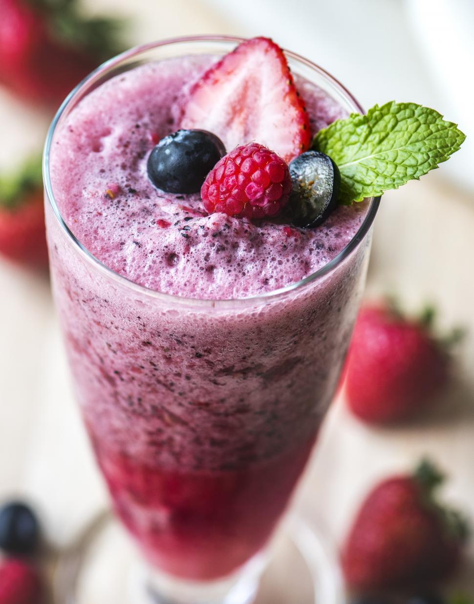 Free Image of Close up of a glass of strawberry, blueberry and raspberry smoothie 