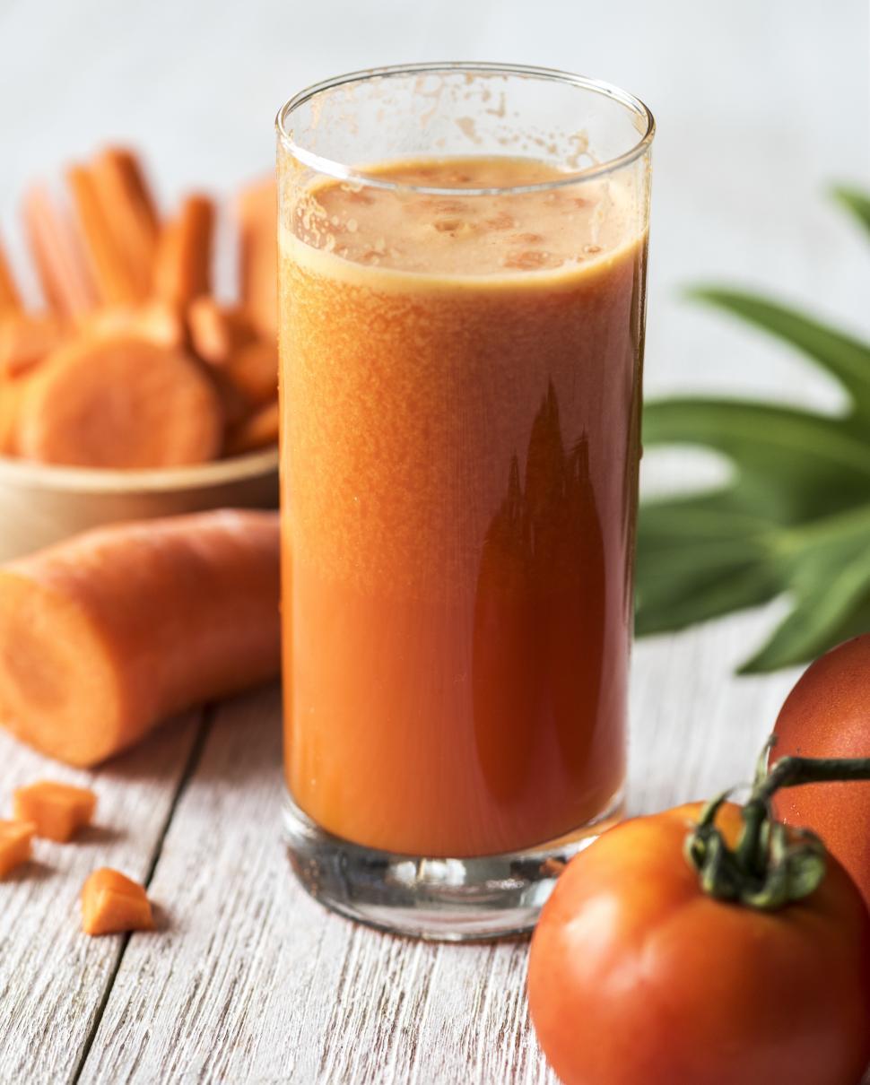 Free Image of Close up of carrot and tomato smoothie served in a glass 