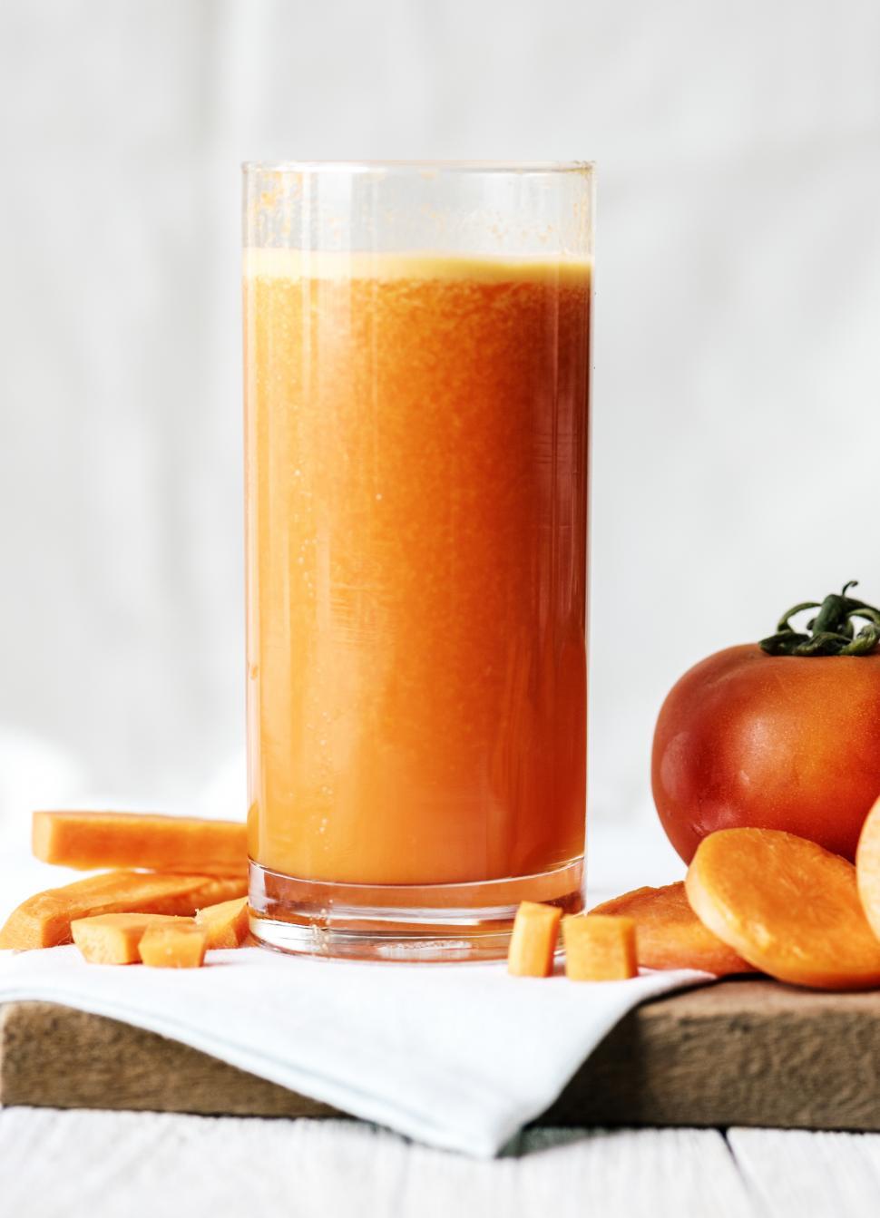 Free Image of Close up of carrot and tomato smoothie served in a glass 