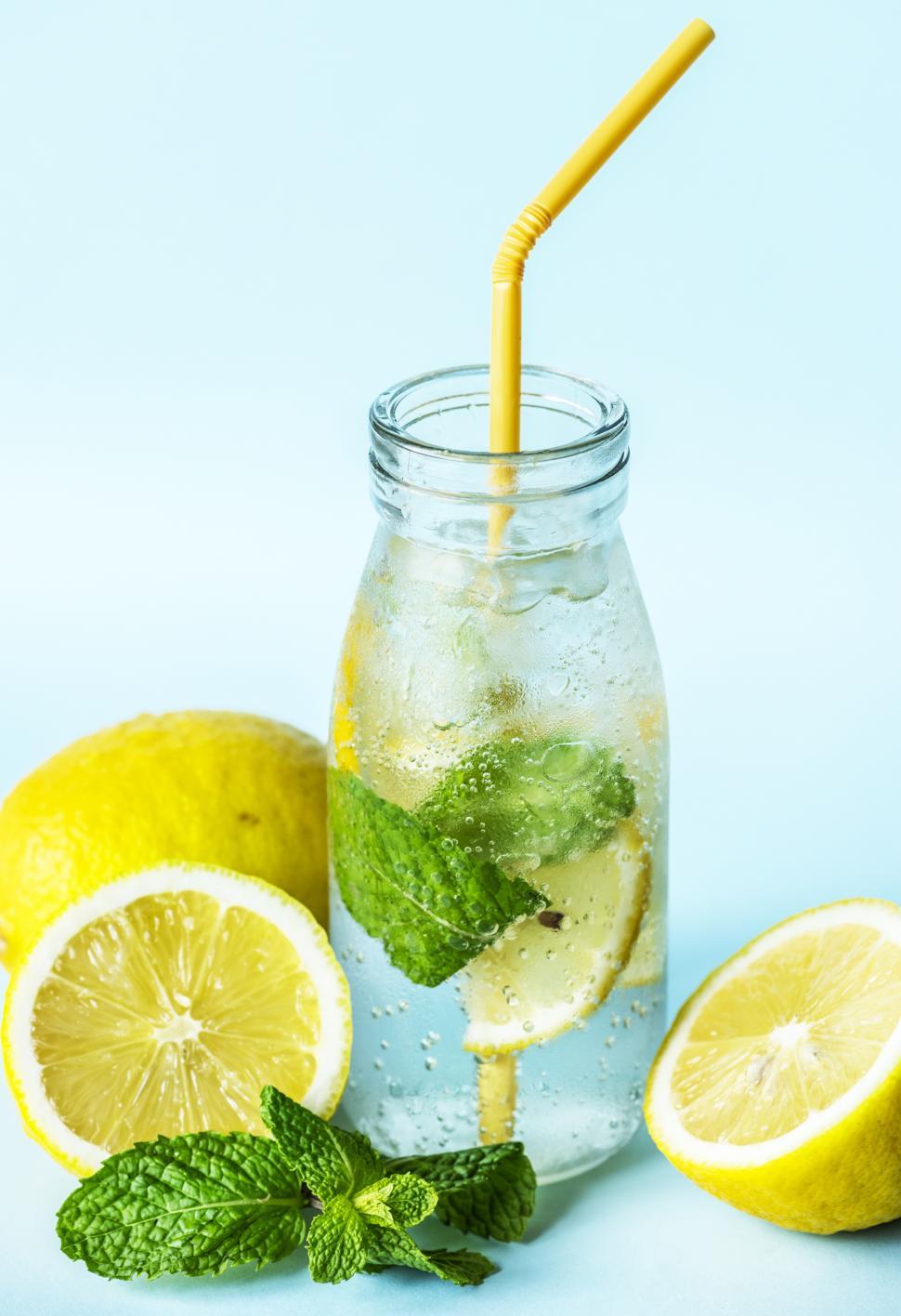 Free Image of Close up of chilled lemonade in a bottle with yellow straw 