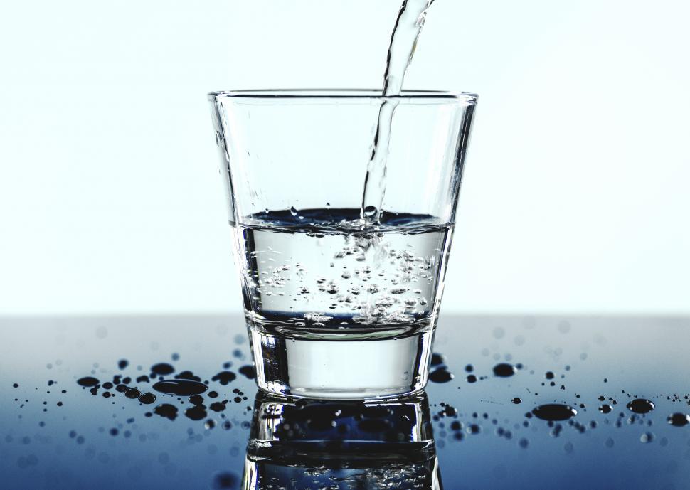 Free Image of White background - clear water being poured into a glass 