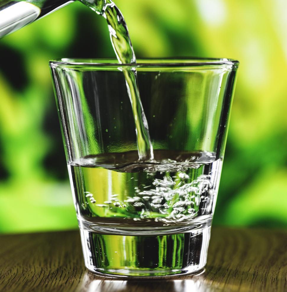 Free Image of Water being poured into a clear glass 