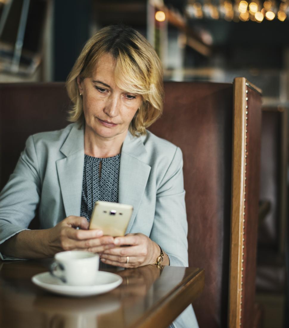 Free Image of A businesswoman staring at her mobile phone 