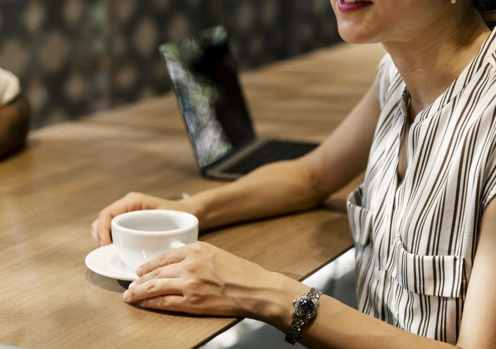 Free Image of An anonymous woman enjoying coffee at a cafe 