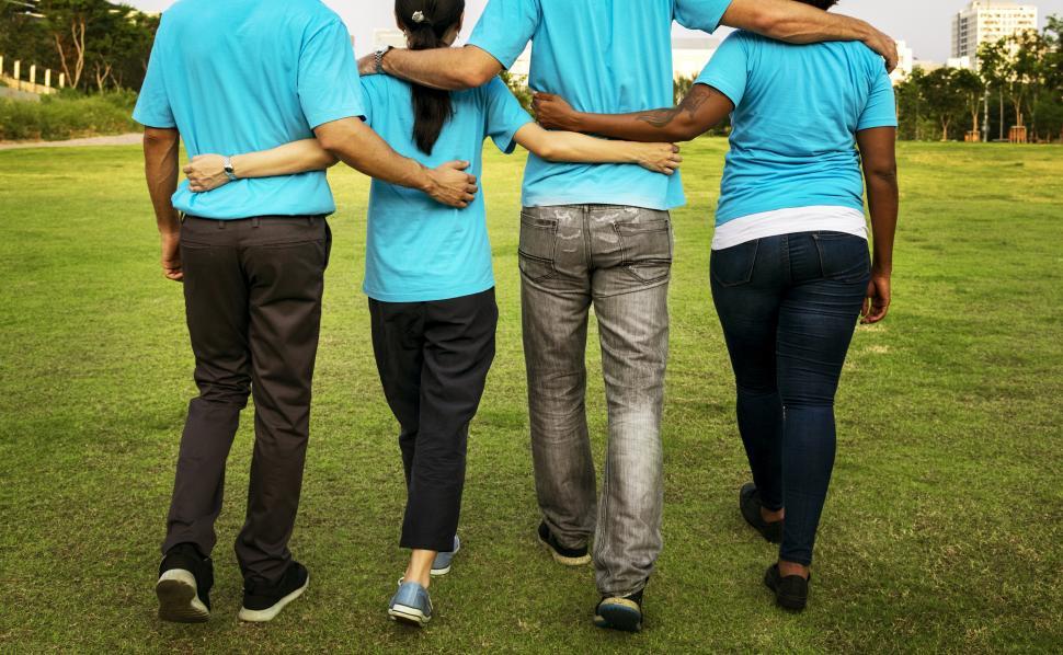 Free Image of A group of multiethnicity volunteers walking together on the grass 