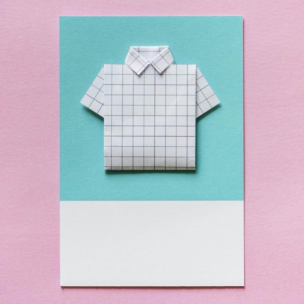 Free Image of Flay lay of a miniature toy shirt on a colored cardboard frame 