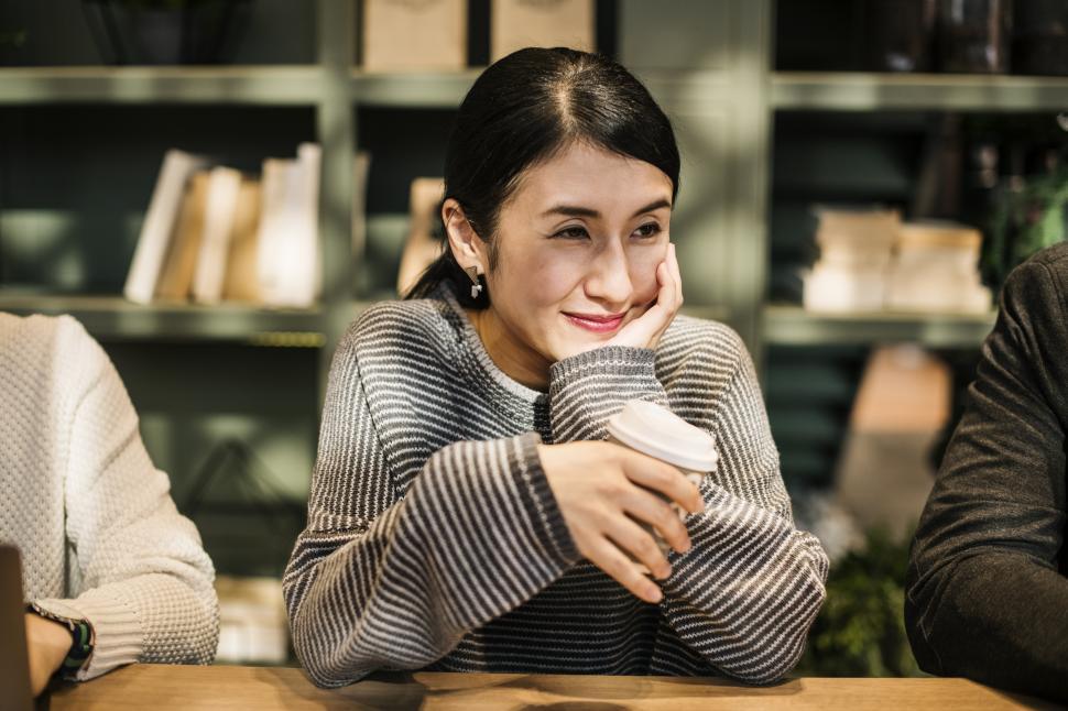 Free Image of A woman enjoying coffee at a cafe 