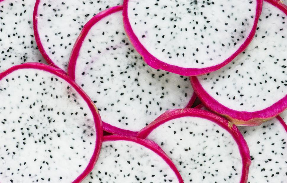 Download Free Stock Photo of Flat lay of dragon fruit slices close up 