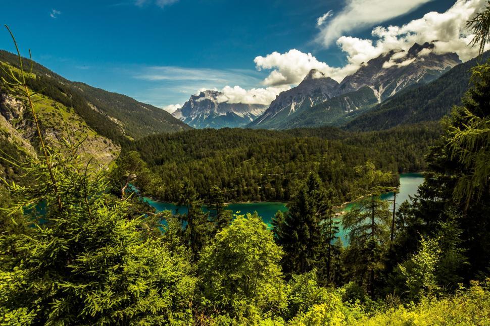 Free Image of austria far right fernpaÃŸ fernsteinsee tyrol lake forest mountains summer mountain lake bergsee b179 far stone sky blue clouds landscape nature alpine vacations rock cloudscape mountain peaks sun rest sky blue tree green area reserve nature reserve environment recovery 