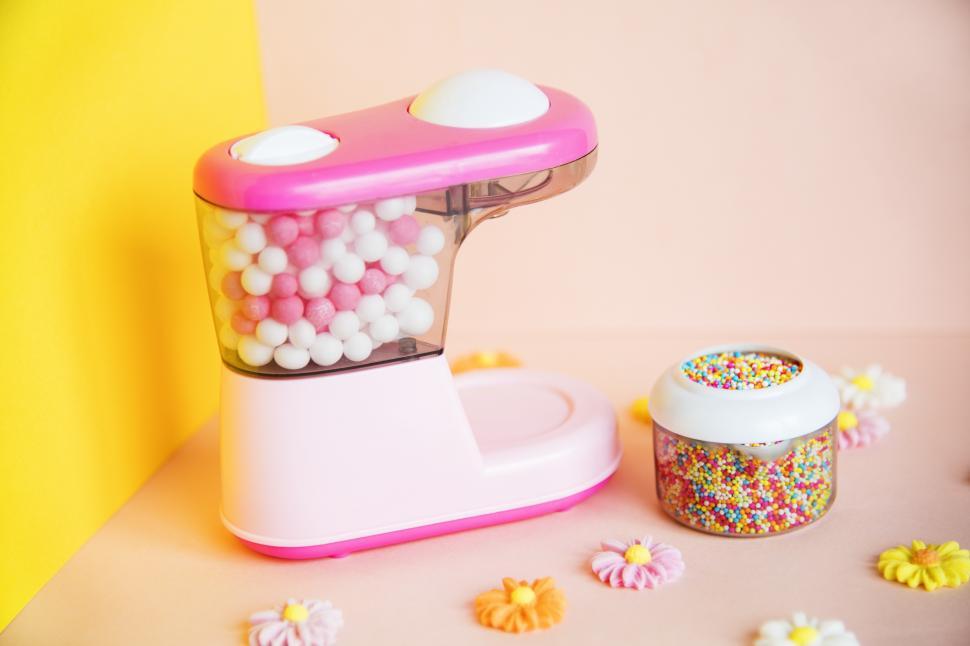 Free Image of Close up of miniature toy blender filled with colorful candies 